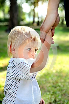 Unhappy Child hold the Parent Hand