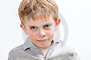 Unhappy conflicted child expressing sadness, anger and disappointment, isolated