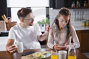 Unhappy couple arguing having disagreement at psychologists office, frustrated young family discussing relationship problems