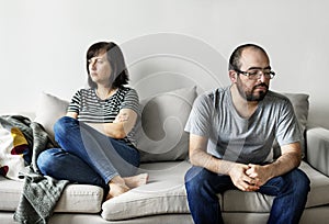 Unhappy couple arguing on the sofa photo