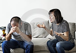 Unhappy couple arguing on the sofa