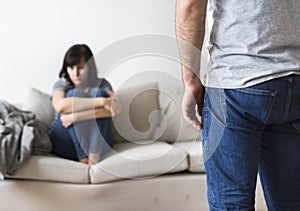 Unhappy couple arguing on the sofa