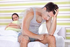 Unhappy couple in bedroom photo