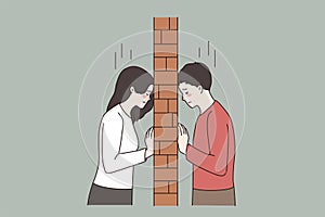 Unhappy couple in fight separated by brick wall