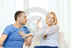 Unhappy couple having argument at home