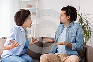 Unhappy couple having argument at home