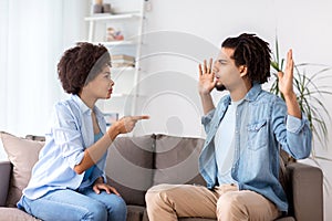 Unhappy couple having argument at home