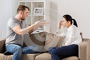 Unhappy couple having argument at home