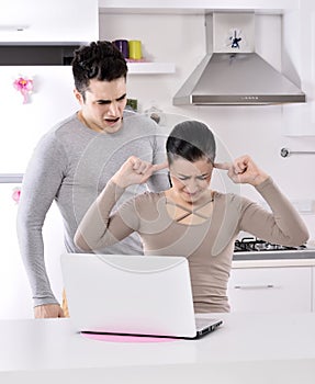 Unhappy couple in the kitchen