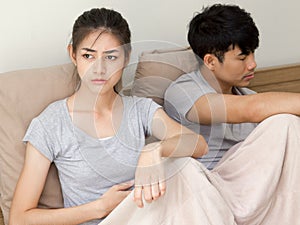 Unhappy couple not talking after an argument in bed at home selective.