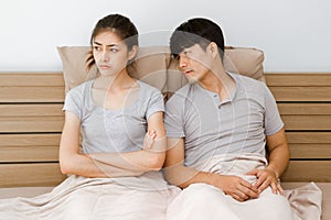Unhappy couple not talking after an argument in bed selective focus on woman face