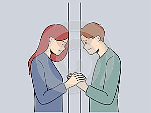 Unhappy couple separated by wall