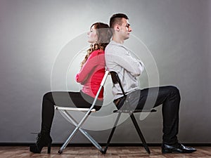 Unhappy couple sitting back to back. Disagreement. photo