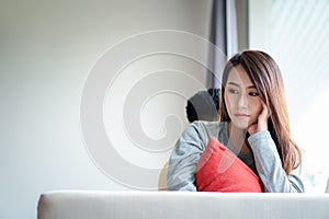 Unhappy Couple sitting behind each other on the couch and avoid talking or looking at each other, Cause of relationship problems