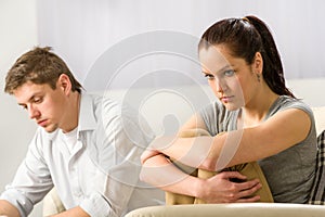 Unhappy couple sitting silently after argument photo