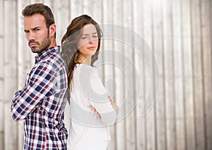 Unhappy couple standing back to back