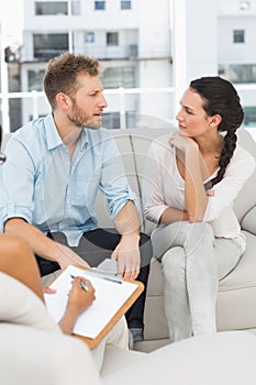 Unhappy couple talking at therapy session