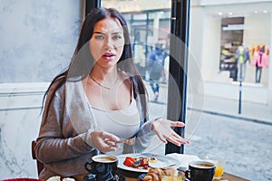 Unhappy customer in restaurant, angry woman