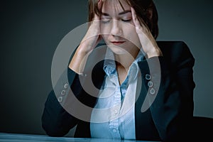 Unhappy and depressed business woman working overtime in office and having a headacheas if she want to say: I hate my work! Low