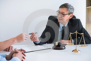 Unhappy divorce couple having conflict, husband and wife during divorce process with senior male lawyer or counselor and couple