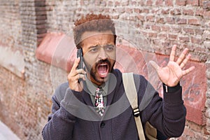 Unhappy entrepreneur shouting during phone call