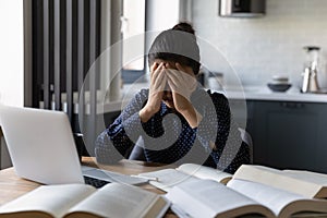 Unhappy ethnic woman distressed with work amount