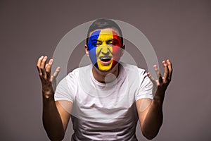 Unhappy and Failure of goal or lose game emotions of Romanian football fan in game supporting of Romania national team