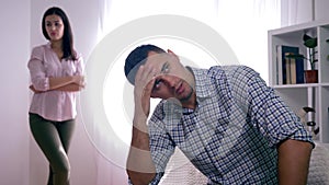 Unhappy family, portrait of frustrated man after quarrel with girl sitting at home folding hands near face and woman