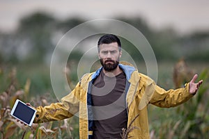 Unhappy farmer in corn field