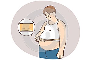 Unhappy fat man measure belly with tape