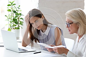 Unhappy female employee bored by colleague lecturing