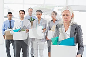 Unhappy fired business people holding box