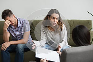 Unhappy frustrated woman sharing problems with counselor, couple