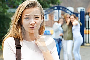 Unhappy Girl Being Gossiped About By School Friends