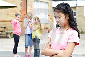 Unhappy Girl Being Gossiped About By School Friends