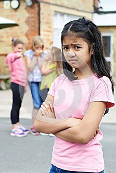 Unhappy Girl Being Gossiped About By School Friends