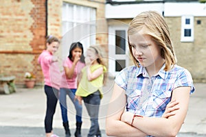 Unhappy Girl Being Gossiped About By School Friends