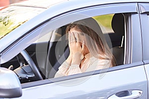 Unhappy girl driver. Shocked and scared. Car accident