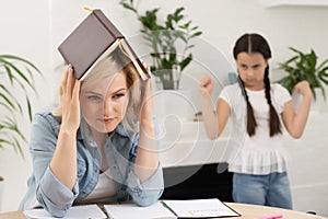 Unhappy girl not talking after an argument with mother in the living room at home