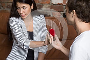 Unhappy girl refusing to marriage proposal of boyfriend