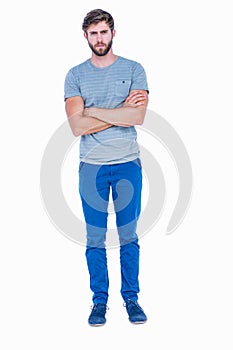 Unhappy handsome man looking at camera with arms crossed