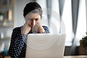 Unhappy hindu woman reading bad news notification, solving problem.