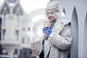 Unhappy homeless woman begging people for money