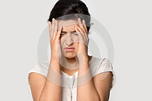 Unhappy Indian woman suffer from migraine overworking
