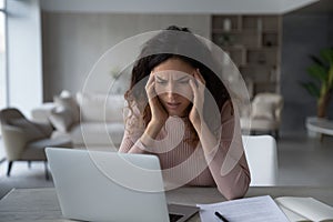 Unhappy Latino woman distressed with work deadline