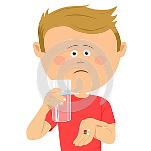 Unhappy little boy with glass of water shows two pils