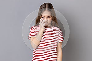 Unhappy little girl hiding face down and crying, upset about loss, feeling sorrow and regret.