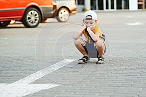 Unhappy lonely child. Boy lost parents at city street