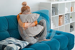 Unhappy lonely depressed woman home, she sitting couch hiding her face pillow, depression concept