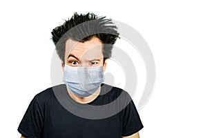 Unhappy, mad person wearing a protective face mask prevent virus infection or pollution on white isolated background